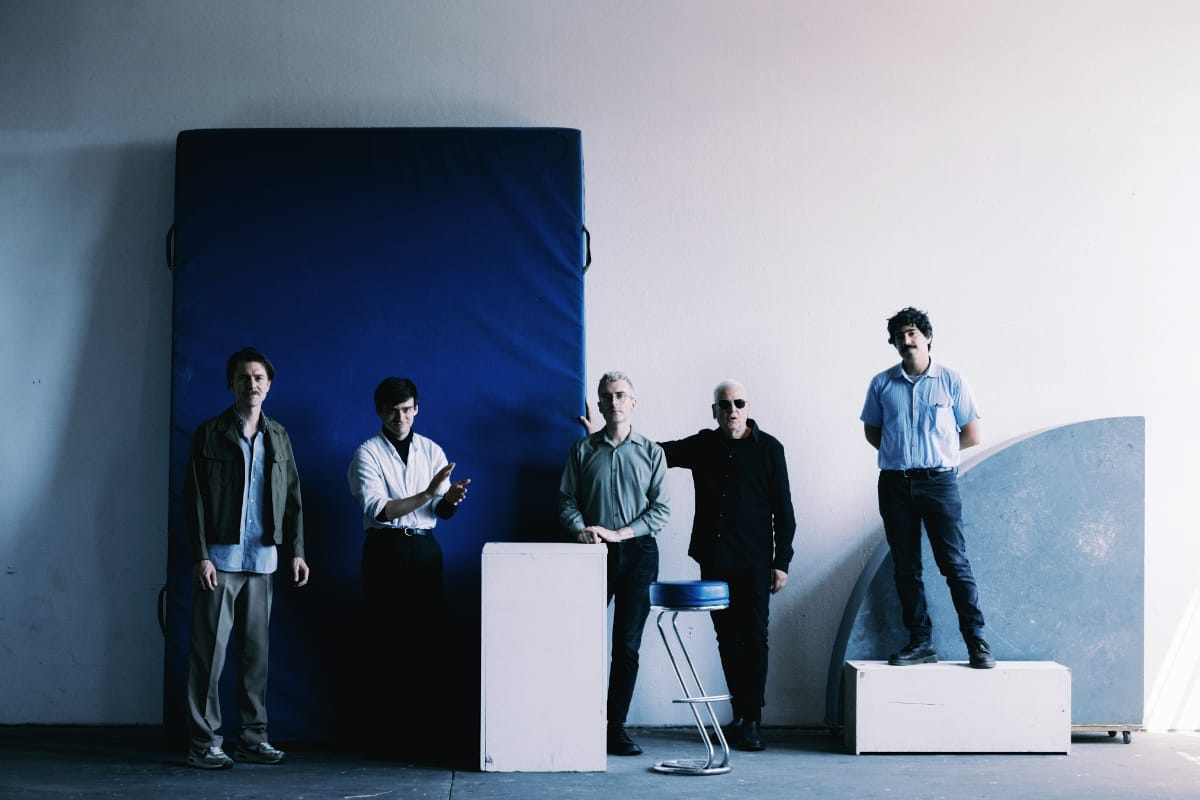 Horse Lords + Arnold Dreyblatt + Andrea Belfi standing in an artsy room. Photo by Camille Blake.