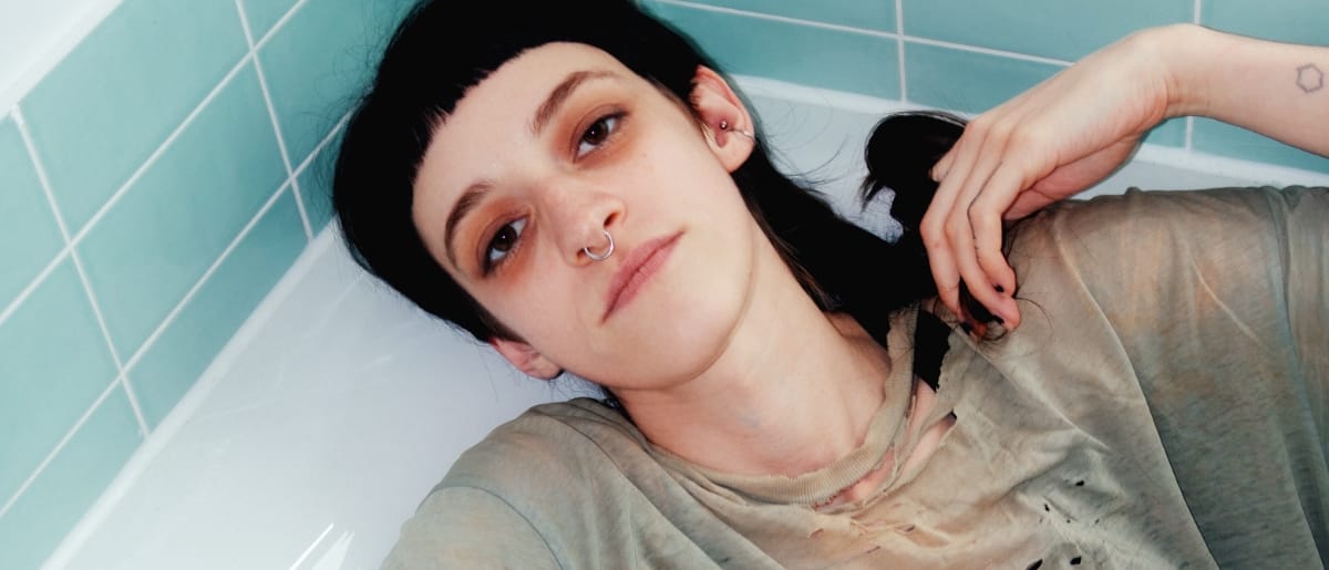 Bridget Ferrill laying in a bathtub. Photo by Elizabeth Davis.