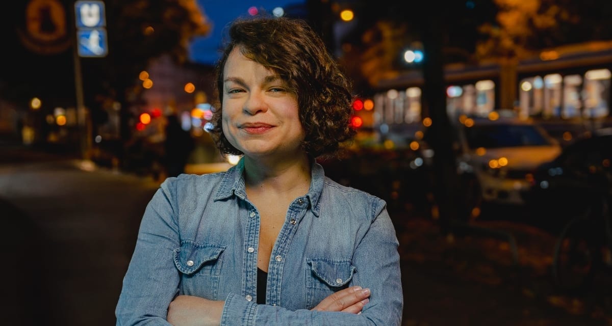 Patricia Brennan standing on a city street at night. Photo by Werner Siebert