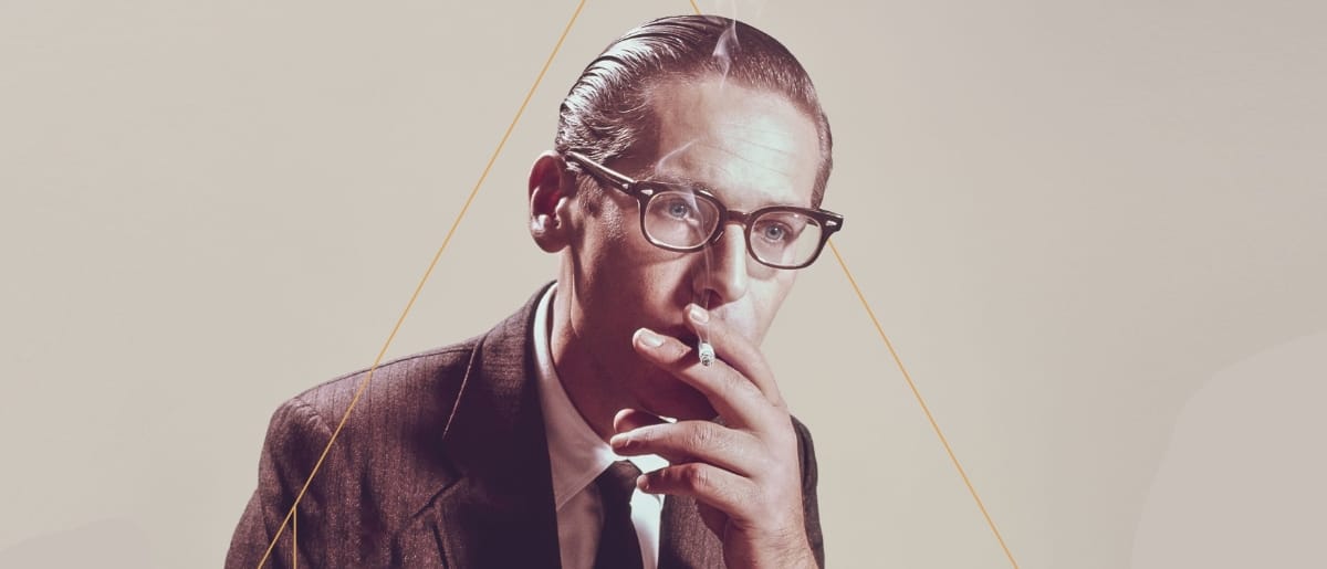 Bill Evans in the early '60s, smoking a cigarette.