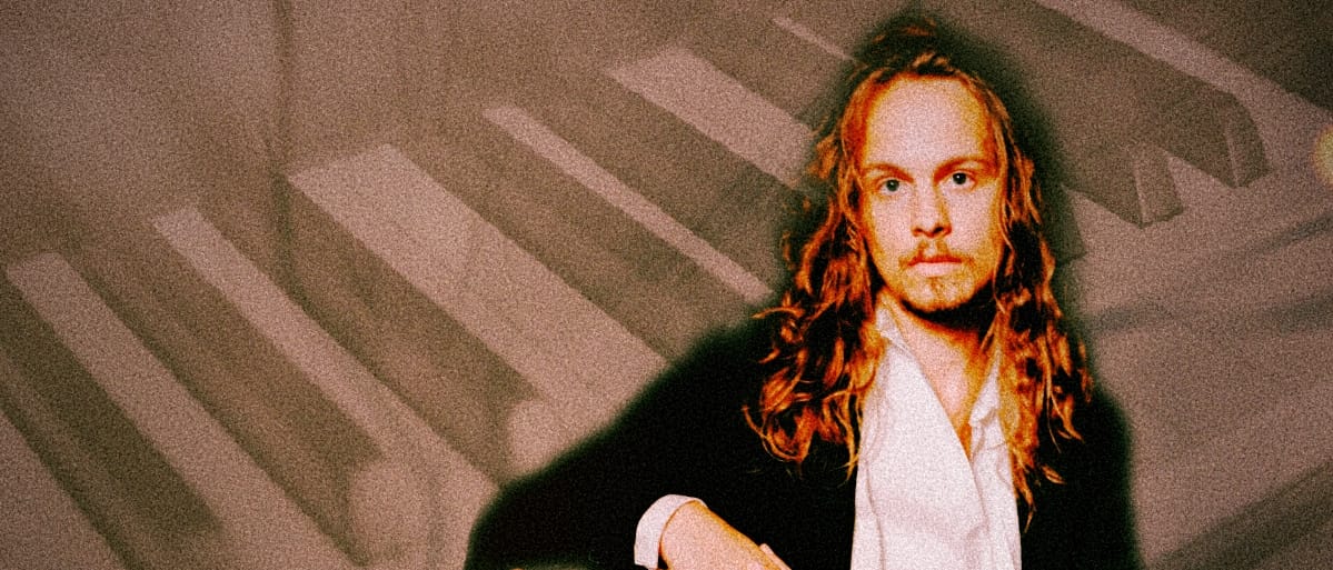 Louis Gardner portrait photo super-impossed in front of piano keys. Photo by Sophia Liv Maguire.