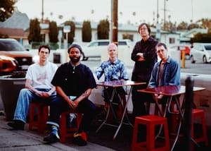 The five members of SML seated at an outdoor dining area somewhere. Photo by Sam Lee.
