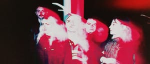 Five members of French band wavepool stand together under dramatic red and white lighting, creating a hazy, overexposed aesthetic. Photo by Charlotte Romer.